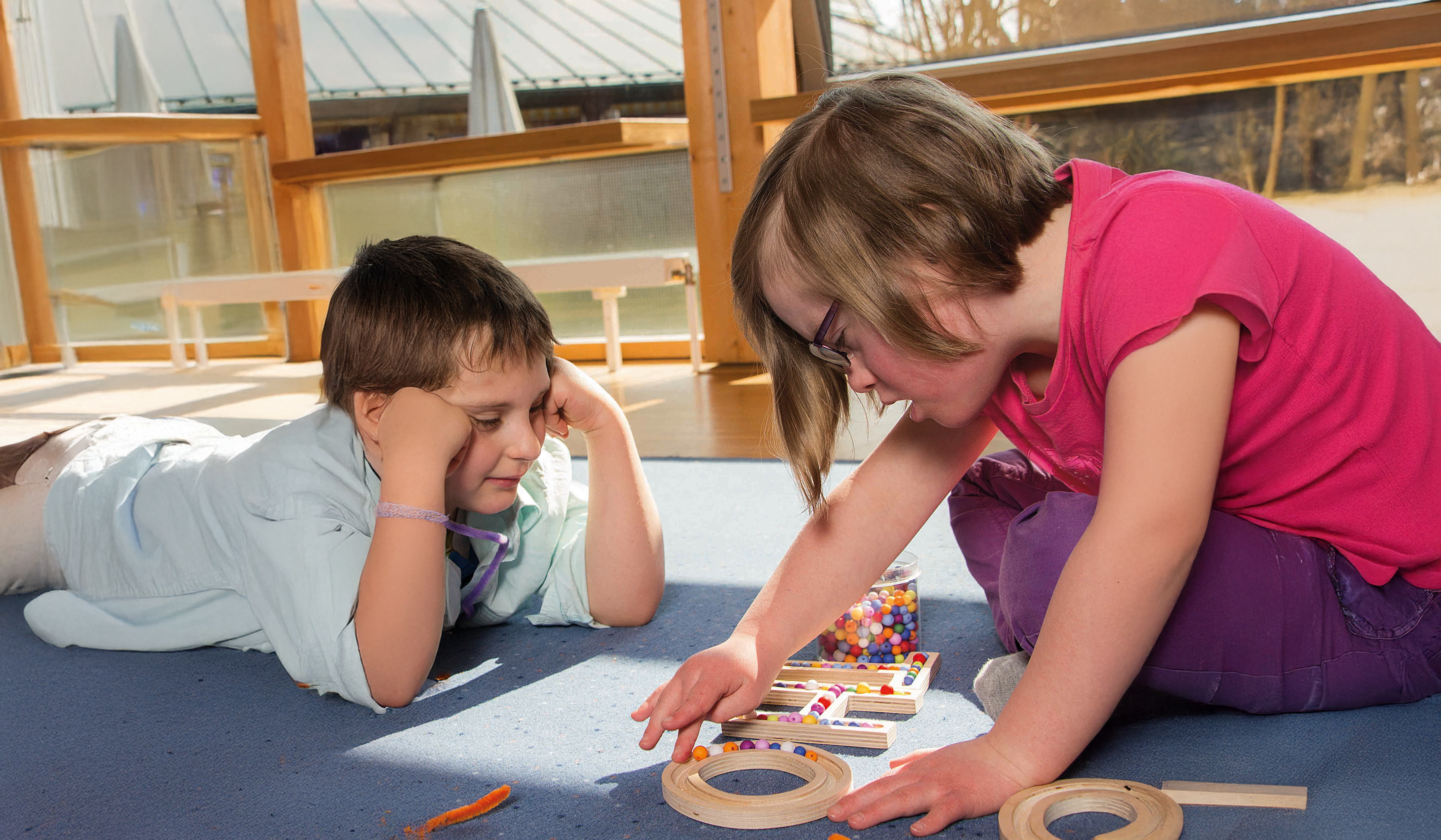 drop of honey on blotting paper, one forming a tight bead, another spreading with a wet ring, overhead shot.