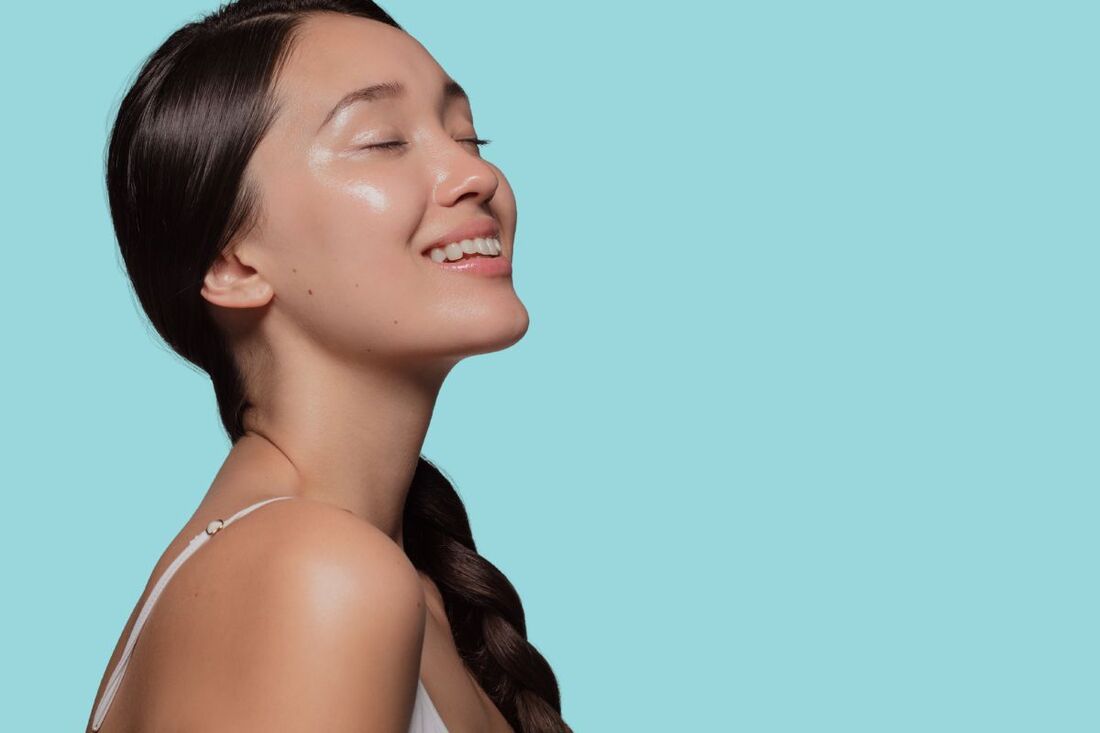 woman rinsing face with cool water, then applying moisturizer, fresh and glowing skin